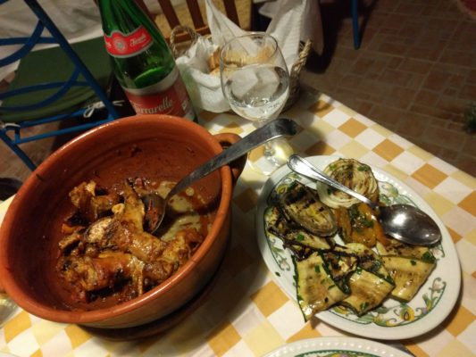 Traditional rabbit dish with a side of grilled veggies