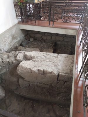 Part of the church's floor has been cut away to reveal the foundations of the old Roman Odeon beneath