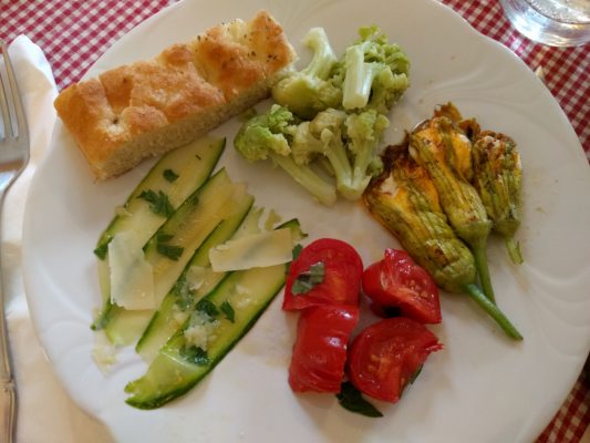 Chad made a delicious appetizer for Fran's birthday - focaccia, broccolo (giant broccoli), stuffed squash blossoms, tomato salad, fresh zucchini