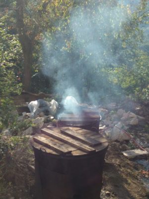 Tomatoes being cooked in someone's side yard so they can be canned for the winter