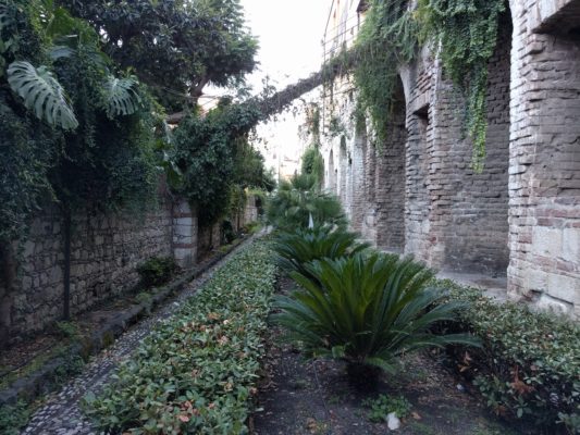 A small city park nestled between two old buildings