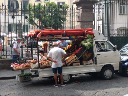 A guy selling produce on the street