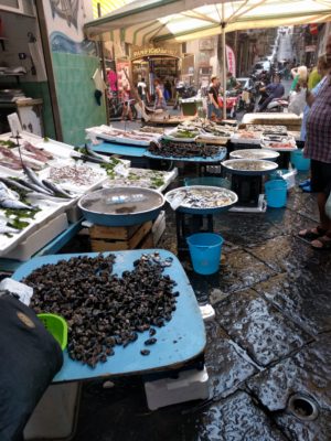 Seafood displayed on the sidewalk outside a shop