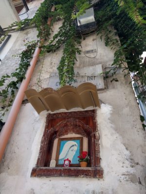 A small  shrine next to a produce shop