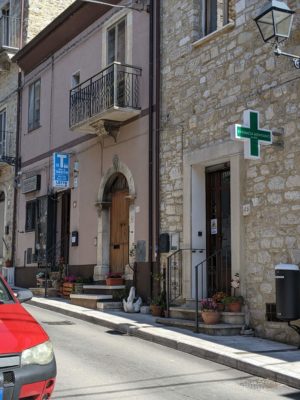 The pharmacy (with the green cross) and the multi-purpose store (with the blue Tabacchi sign, selling toys, jewelry, groceries, etc)