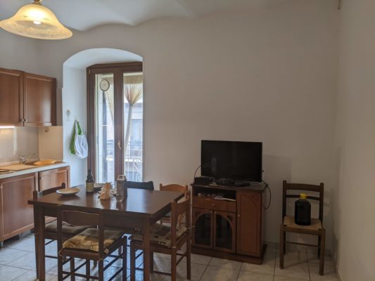 dining table and TV and 5-liter jug of red wine sitting on a chair