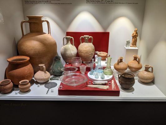 The items on the red display platform and to the left were discovered in female graves, the items to the right are from male graves