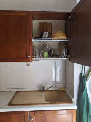 the cabinet over the sink has a dish rack - we've seen this in several apartments in Italy - and the sink has a built-in dish drain area - genius!