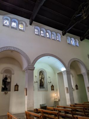 A view of the side aisle and windows above