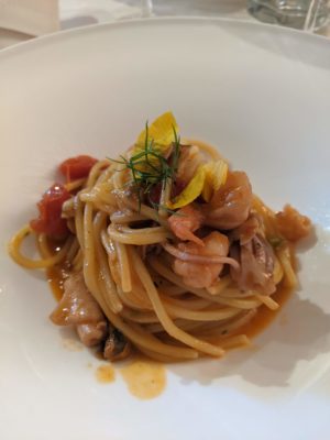 fresh pasta with seafood - shrimp, mussels, something tubular, little tomatoes