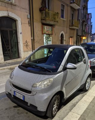 This Smart car is covered in a houndstooth pattern