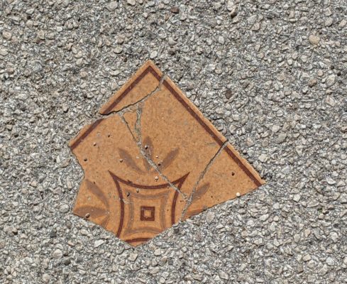 Here's a piece of tile embedded in the asphalt on the street