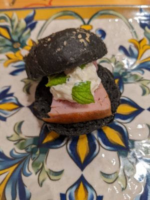 lunch started with an amuse-bouche of a little fish sandwich - the bread was made with squid ink, and the filling was seared fish with bufalla cream and mint