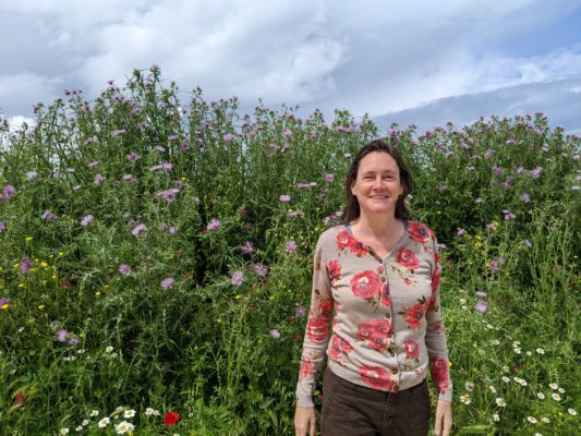 me with tall wild flowers behind me