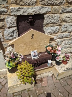 one of the oldest graves has been spruced up with a new plaque and flowers