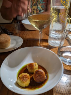 potato dumplings filled with shredded chicken served in a white wine reduction, a local white wine