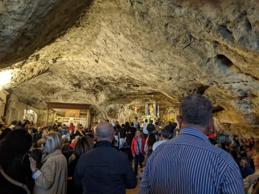 the cave where Archangel Michael appeared - now a pilgrimage site - and filled with tourists who were sitting down for Mass