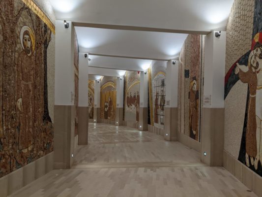 mosaic hallway down to the modern crypt