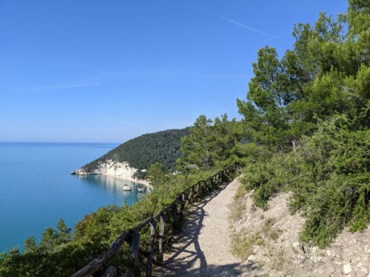 a trail on the mountain with a view of the sea