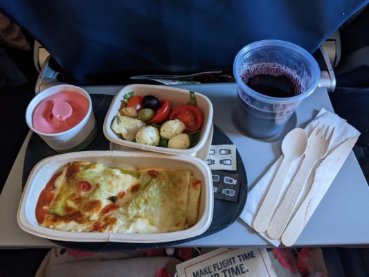 lunch on the plane - veggie lasagna, Italian salad with tomatoes/olives/mozzarella, strawberry gelato, red wine