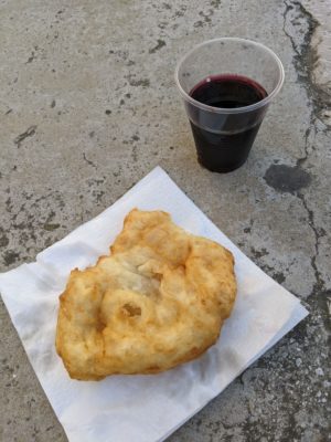 fried pizza dough snack with a free glass of chilled red wine