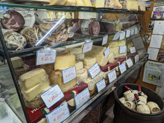 the deli case with cheese and meat